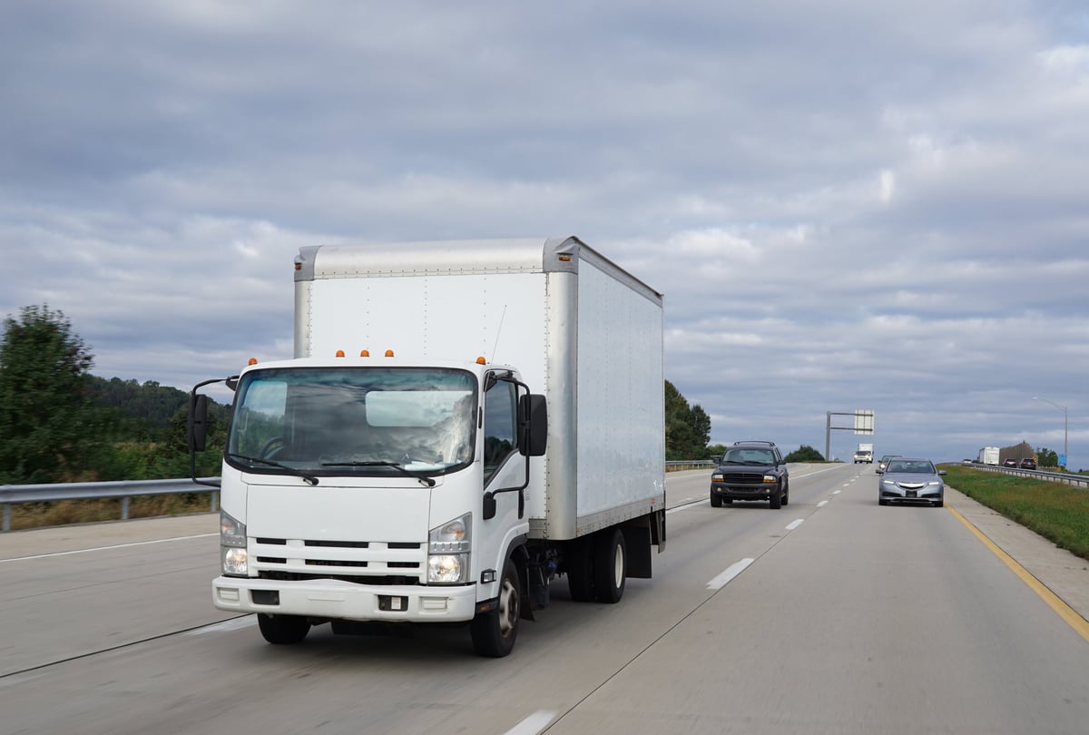 Box truck delivering goods on a highway